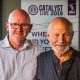 Mark Ord and Stanley Hauerwas in front of a Catalyst Live banner